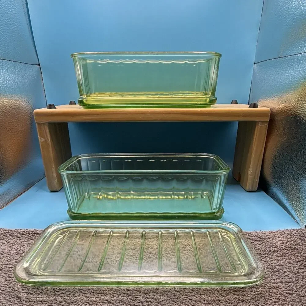 Uranium depression glass refrigerator dishes from the 30’s glows green. One lid.